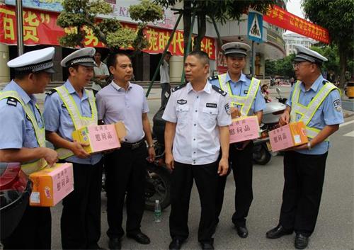 梧州市公安局副局长陆志光同志与正在执勤的民警,交通协管员亲切握手